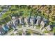 This aerial view showcases a neighborhood with well-maintained lawns, mature trees, and attractive home exteriors at 2250 Windcrest Lake Cir, Orlando, FL 32824
