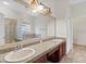 Bathroom featuring granite countertops, double sinks, vanity, and tile flooring at 2250 Windcrest Lake Cir, Orlando, FL 32824