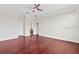 Expansive bedroom featuring hardwood floors, a ceiling fan, and an ensuite bathroom at 2250 Windcrest Lake Cir, Orlando, FL 32824