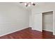 Bedroom with ceiling fan, hardwood floors, closet, and chair rail at 2250 Windcrest Lake Cir, Orlando, FL 32824