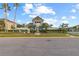 Community recreation building surrounded by lush greenery, tall palm trees and colorful decorations at 2250 Windcrest Lake Cir, Orlando, FL 32824