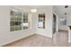 Bright dining area with large windows offering views of the well-manicured backyard at 2250 Windcrest Lake Cir, Orlando, FL 32824