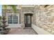Inviting front entrance with brick accents, a decorative fountain, and an elegant front door at 2250 Windcrest Lake Cir, Orlando, FL 32824