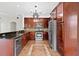 Well-equipped kitchen with stainless steel appliances, dark wood cabinets, and granite countertops at 2250 Windcrest Lake Cir, Orlando, FL 32824