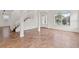 Spacious living room featuring tile flooring, staircase, and ample natural light at 2250 Windcrest Lake Cir, Orlando, FL 32824
