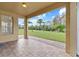 Relaxing covered patio offering a serene view of the expansive, well-maintained backyard at 2250 Windcrest Lake Cir, Orlando, FL 32824
