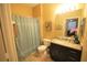 Bathroom featuring vanity with granite countertop, shower with curtain and neutral wall color at 2305 Silver Palm Dr # 102, Kissimmee, FL 34747