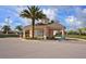 Gated community entrance with classic architecture, palm trees, and well-maintained landscaping at 2305 Silver Palm Dr # 102, Kissimmee, FL 34747