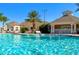 Sparkling community pool surrounded by well-maintained landscaping and luxurious clubhouse at 2305 Silver Palm Dr # 102, Kissimmee, FL 34747