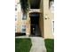 Building exterior featuring well-maintained landscaping and visible unit address at 2305 Silver Palm Dr # 102, Kissimmee, FL 34747