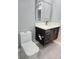 Modern bathroom featuring a toilet and vanity with a sleek design, offering a functional space at 231 Old Mill Cir, Kissimmee, FL 34746