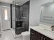 Elegant bathroom featuring a glass-enclosed shower, toilet and a vanity with modern fixtures and sleek design at 231 Old Mill Cir, Kissimmee, FL 34746