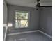 This bedroom features a ceiling fan, window, and tile flooring at 231 Old Mill Cir, Kissimmee, FL 34746
