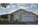 Inviting single-Gathering home boasting a well-maintained lawn and attached garage at 231 Old Mill Cir, Kissimmee, FL 34746