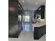 Modern kitchen featuring dark cabinets, stainless steel appliances, and marble floors at 231 Old Mill Cir, Kissimmee, FL 34746