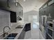 Contemporary kitchen with dark cabinets, marble counters, and stainless steel appliances at 231 Old Mill Cir, Kissimmee, FL 34746