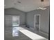 Bright and airy living room with sliding doors, neutral color palette and modern light fixture at 231 Old Mill Cir, Kissimmee, FL 34746