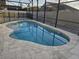 Sparkling inground pool enclosed by a screened enclosure and -safe fencing for peace of mind at 231 Old Mill Cir, Kissimmee, FL 34746