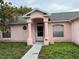Front view of a single story home highlighting the entryway, pillars, and front windows at 2417 Lancashire Ln, Kissimmee, FL 34743
