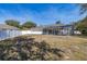 Lush backyard with a screened-in pool, a white fence and mature trees, perfect for outdoor relaxation at 248 Breezy Oaks Ct, Davenport, FL 33896