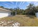 Spacious backyard with a screened-in pool area and a partial view of the surrounding greenery at 248 Breezy Oaks Ct, Davenport, FL 33896