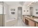 Bright bathroom with a tub, shower, and double sink at 248 Breezy Oaks Ct, Davenport, FL 33896