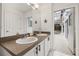 Spacious bathroom with double sinks, a large mirror, and access to the pool at 248 Breezy Oaks Ct, Davenport, FL 33896