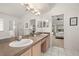 A well-lit main bathroom boasts double sinks with a shower and tub at 248 Breezy Oaks Ct, Davenport, FL 33896