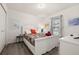 Cozy bedroom features a comfortable bed, wood floors, and a sunlit window at 248 Breezy Oaks Ct, Davenport, FL 33896