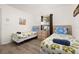 Comfortable bedroom with two twin beds, neutral walls, and a bright window at 248 Breezy Oaks Ct, Davenport, FL 33896