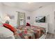 Comfortable bedroom with a TV, colorful quilt, and a bright window at 248 Breezy Oaks Ct, Davenport, FL 33896