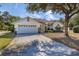 Charming single-story home with an attached two-car garage and well-maintained front yard landscaping at 248 Breezy Oaks Ct, Davenport, FL 33896