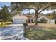 Charming single-story home with an attached two-car garage and mature landscaping in a serene neighborhood at 248 Breezy Oaks Ct, Davenport, FL 33896