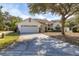 Charming single-story home with an attached two-car garage and mature landscaping in a serene neighborhood at 248 Breezy Oaks Ct, Davenport, FL 33896