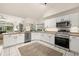 Modern kitchen with stainless steel appliances and white cabinets at 248 Breezy Oaks Ct, Davenport, FL 33896