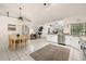 Bright eat-in kitchen features white cabinets and stainless steel appliances with an open floor plan at 248 Breezy Oaks Ct, Davenport, FL 33896
