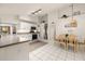 Bright kitchen and dining area with white cabinets and stainless steel appliances at 248 Breezy Oaks Ct, Davenport, FL 33896
