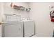Functional laundry room with washer, dryer, and ample storage space at 248 Breezy Oaks Ct, Davenport, FL 33896