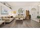 Bright living room featuring wood floors, neutral walls, and a large arched window at 248 Breezy Oaks Ct, Davenport, FL 33896