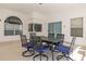 Covered patio with dining table and chairs perfect for outdoor entertaining at 248 Breezy Oaks Ct, Davenport, FL 33896
