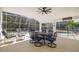 Covered patio featuring an outdoor dining set and relaxing seating area overlooking the pool at 248 Breezy Oaks Ct, Davenport, FL 33896