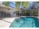 Inviting screened-in pool with a safety fence, adjacent to the covered lanai, perfect for outdoor enjoyment at 248 Breezy Oaks Ct, Davenport, FL 33896