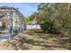 View of a large backyard from the screened porch with views of the property line and surrounding trees at 248 Breezy Oaks Ct, Davenport, FL 33896