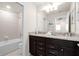 Bathroom features dual granite vanity, modern fixtures, and tub/shower combo at 281 Jetty Way, Davenport, FL 33897