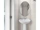 Bathroom featuring a pedestal sink and oval mirror at 281 Jetty Way, Davenport, FL 33897