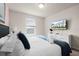 Bright bedroom featuring a large window and a modern TV at 281 Jetty Way, Davenport, FL 33897