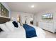 Bedroom boasts a white-mirrored dresser and an accessible ensuite bathroom at 281 Jetty Way, Davenport, FL 33897