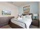 Relaxing bedroom featuring a decorative painting, soft lamps, and gray furniture at 281 Jetty Way, Davenport, FL 33897