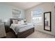 Comfortable bedroom with a large window, soft rug, and wood furniture at 281 Jetty Way, Davenport, FL 33897