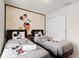 Charming bedroom with two beds and fun Mickey Mouse themed decor at 281 Jetty Way, Davenport, FL 33897
